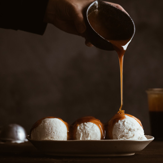 burnt caramel sauce being poured on ice cream