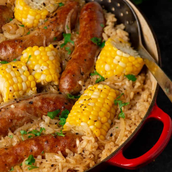 A skillet of baked rice with Italian sausage and corn