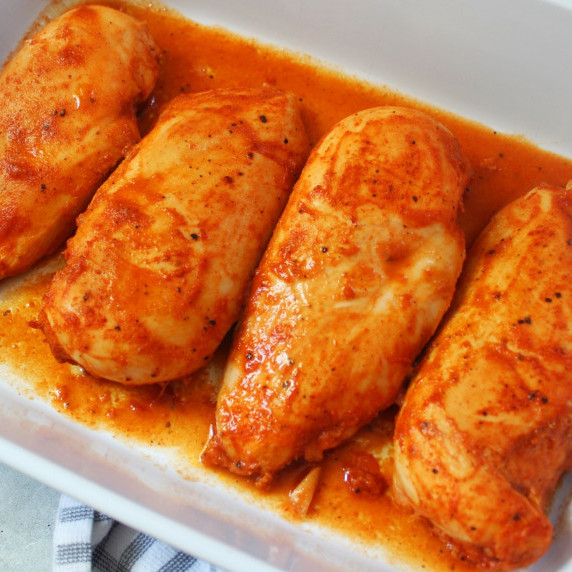 Bbq chicken breasts baked in a white dish. 