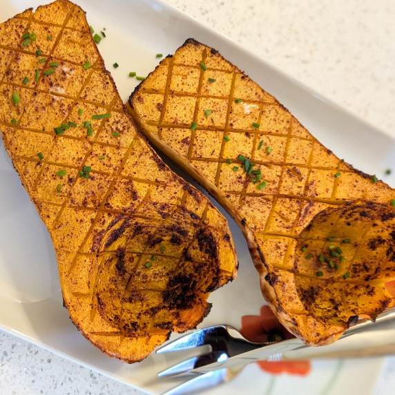 oven roasted butternut squash with sumac, nutmeg, and chives on a serving plate