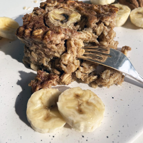 slice of banana bread baked oats with fork and sliced bananas