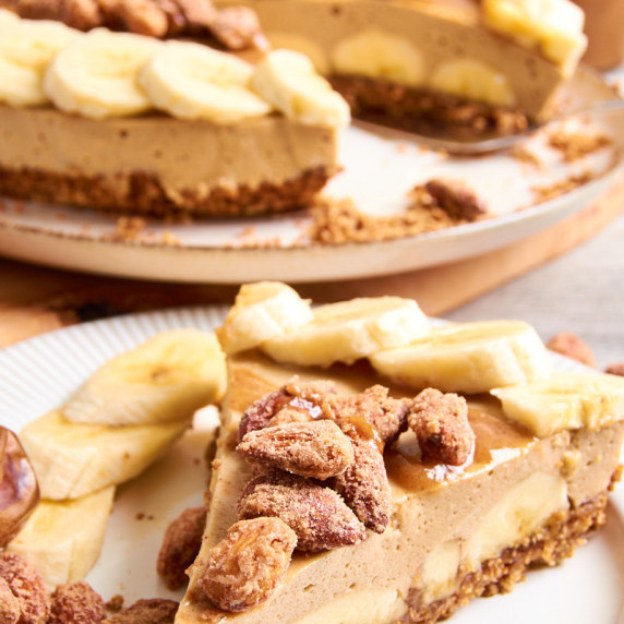 Banoffee Protein Mousse Pie on a plate, covered with caramalized cinnamon almonds.