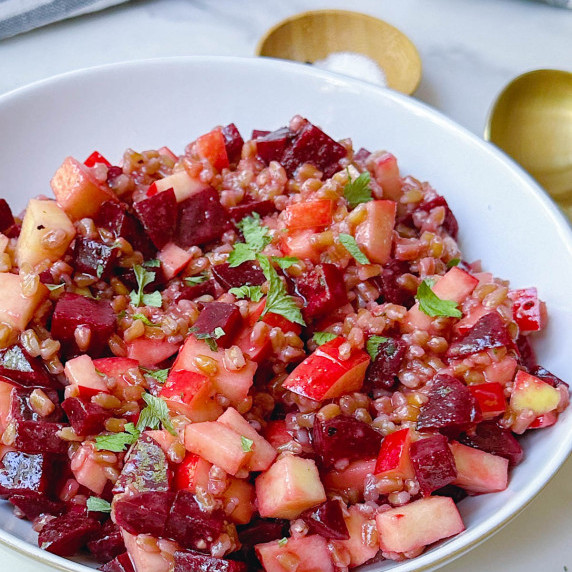 finished beet apple farro salad in a white bowl