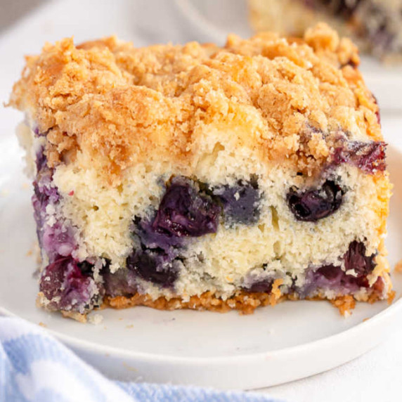 a slice of blueberry buckle on a white plate