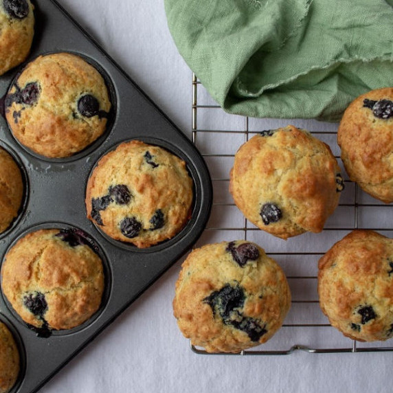 Blueberry Muffins on a rack and in the pan from above