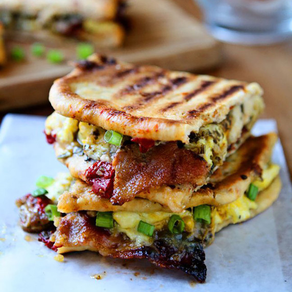 Close up of stacked breakfast panini on a piece of wax paper