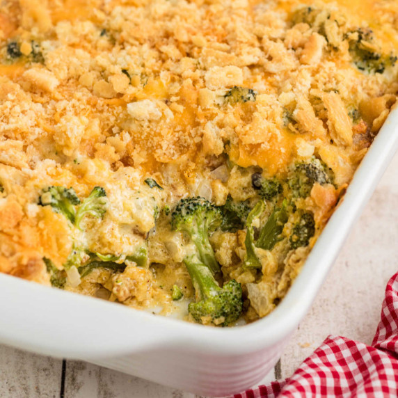 Close up of the corner of a broccoli casserole dish, with a scoop missing.