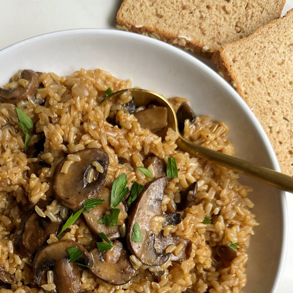 finished instant pot brown rice risotto on a white plate