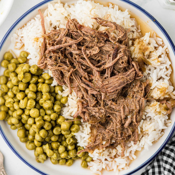 Overhead shot of Cajun rice and gravy with green peas.