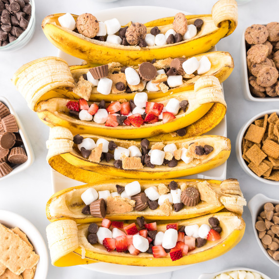 6 banana boats filled with chocolate, marshmallows, graham crackers, & strawberries pieces.