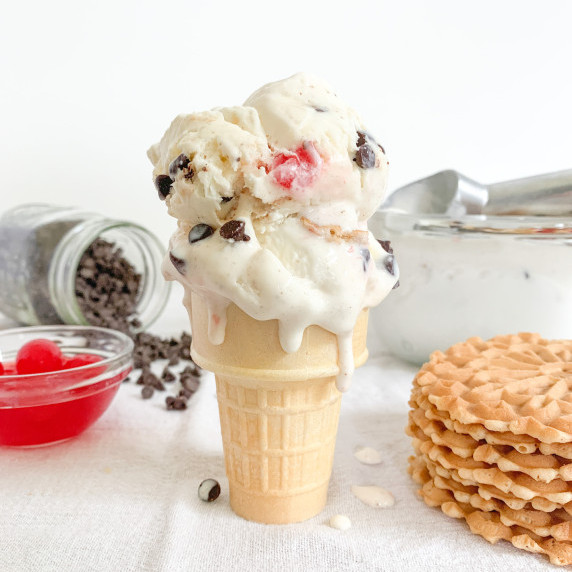 two scoops of cannoli ice cream on a sugar cone