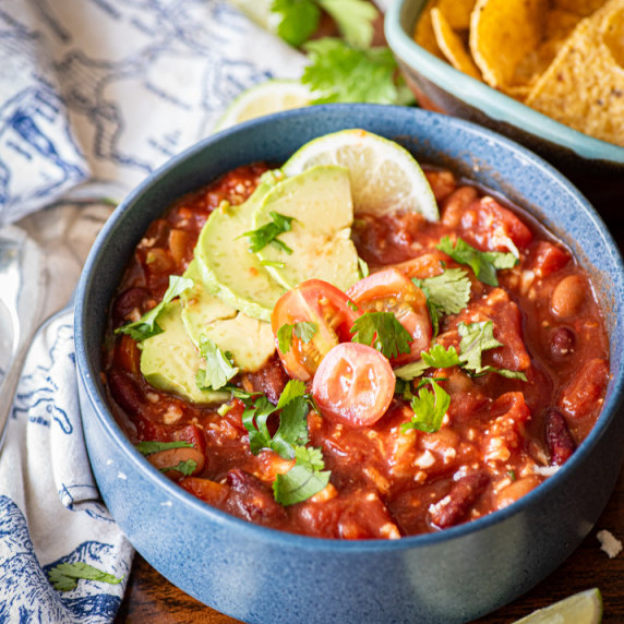 A bowl of cauliflower chili with toppings