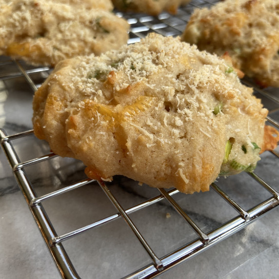 Cheddar and onion biscuits on a wire rack.