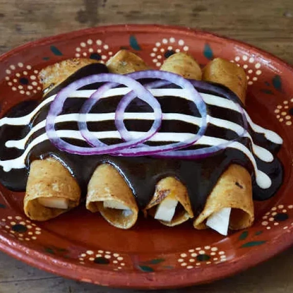 Cheese Enchiladas with Mole Sauce on a plate