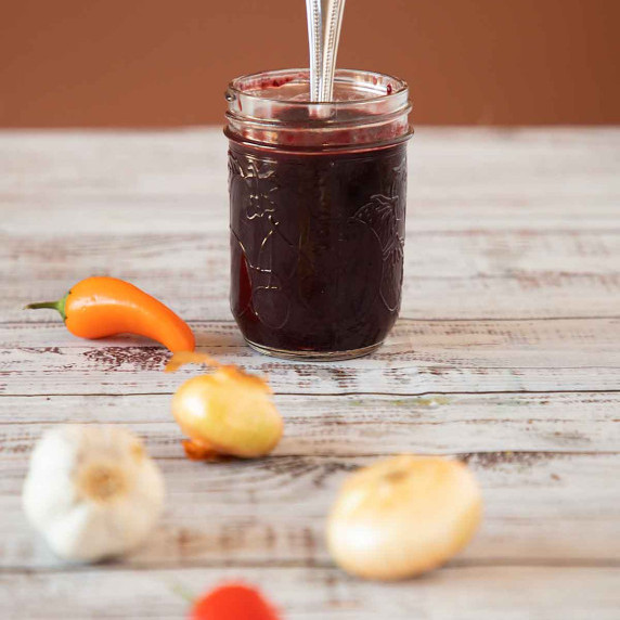 Cherry BBQ sauce in jar with spoon 