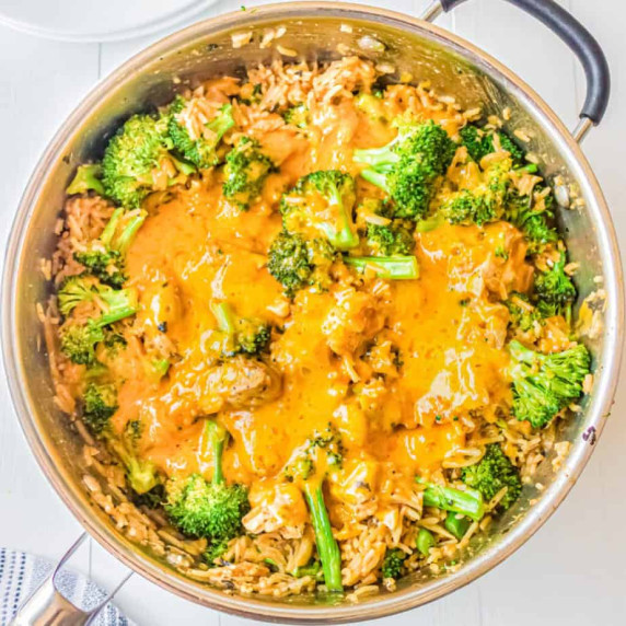 Cheesy chicken broccoli rice dish in deep skillet.