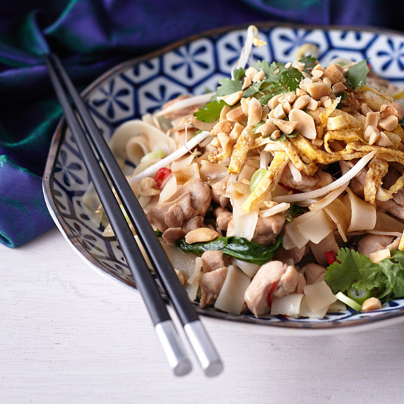 Chicken Pad Thai with chicken, sprouts, spinach, chopped nuts, coriander, chilli and rice noodles