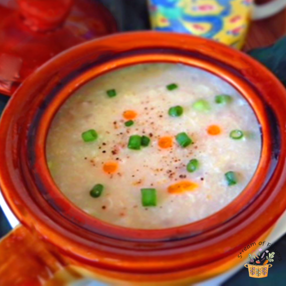 Chinese chicken corn soup in an orange bowl