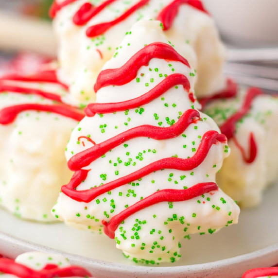 Copycat Little Debbie Christmas Cake covered in white chocolate with red frosting & green sprinkles.