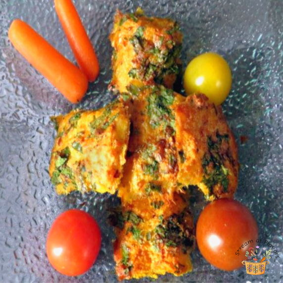 Cilantro fish made with spices, egg, and cilantro with tomatoes and carrots