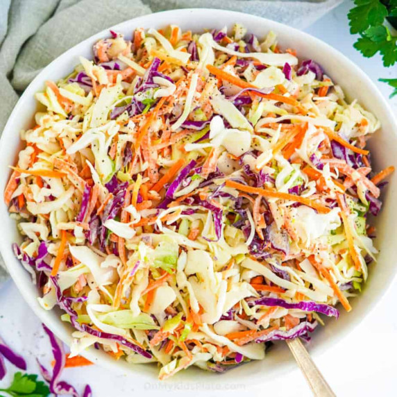 Coleslaw in a bowl form overhead with a serving spoon.