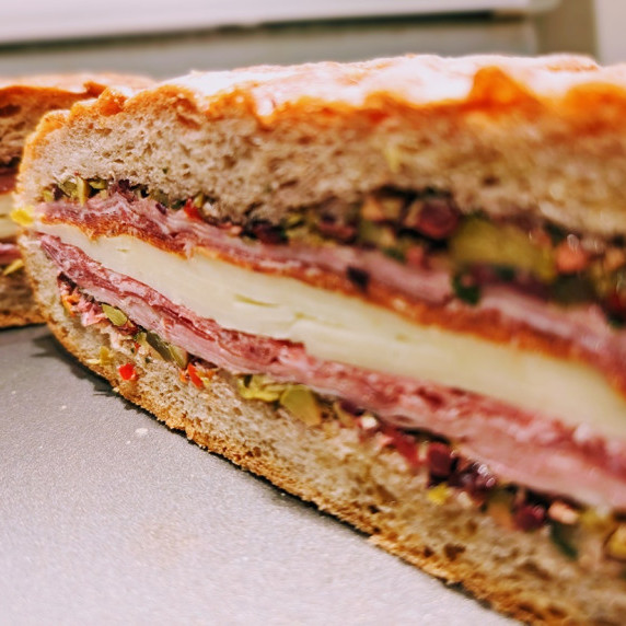 cross-section of muffaletta sandwich on a plate