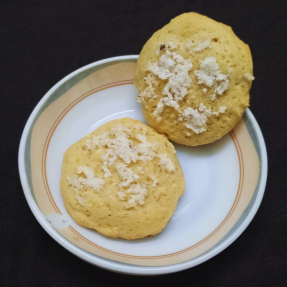 Two coconut cookies in a plate