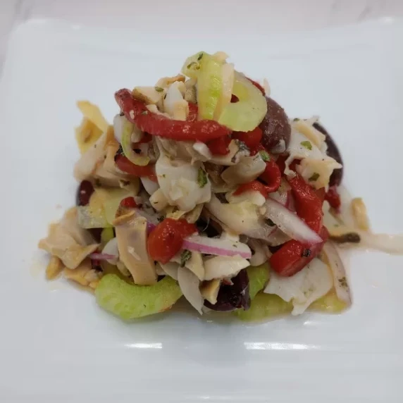 Sliced conch mixed with peppers, olives, onions, artichokes, oil, and vinegar and served cold.