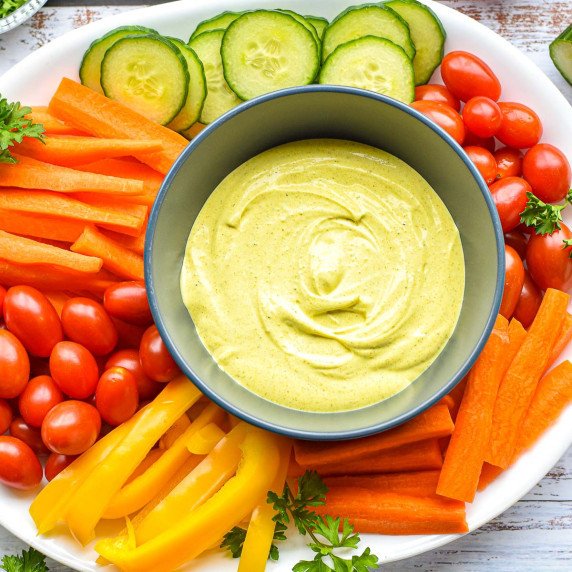 overhead shot of curry dip on a crudité platter.