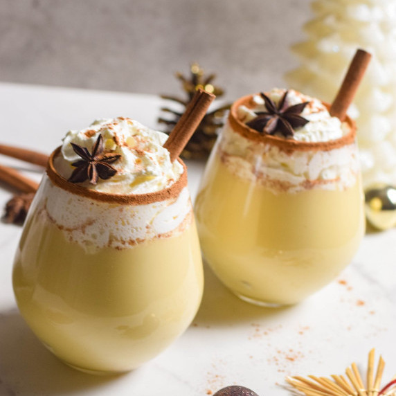 Eggnog with whipped cream in a glass.