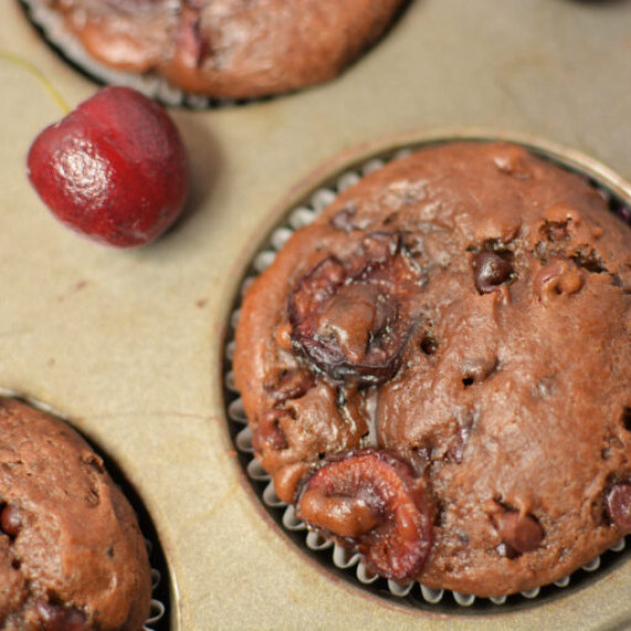 a chocolate cherry muffin baked in a muffin pan.