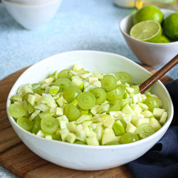 chopped green grapes, fennel and green apples in a white bowl