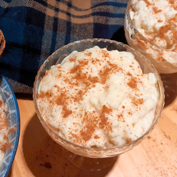 arroz con leche served in a glass with a sprinkle of cinnamon