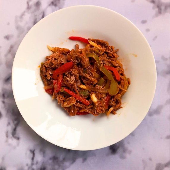 ropa vieja served with white rice and fried ripe plantain