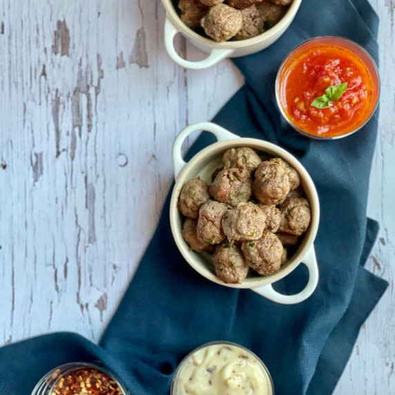 Meatballs in bowl with serving dips