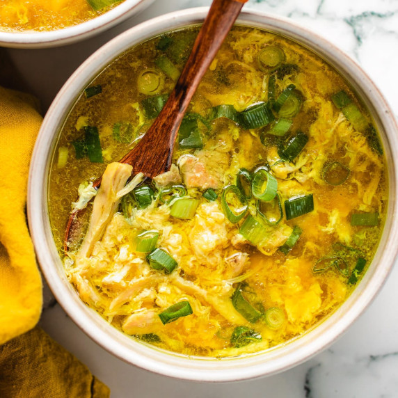Fluffy chicken egg drop soup in a white bowl. 