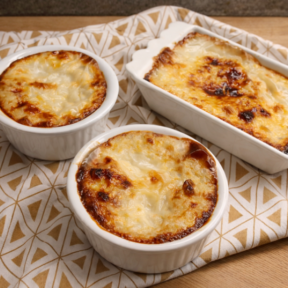 Turkish baked rice pudding with caramelized tops in white ramekins.
