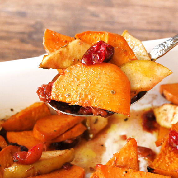 A spoonful of sweet potatoes with cranberries.
