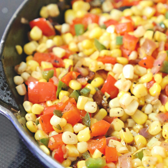 Skillet with corn, tomatoes, bacon, and jalapenos.