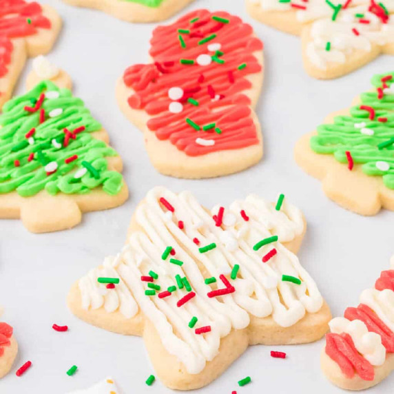 Frosted sugar cookies shaped like stars, Christmas trees and mittens.