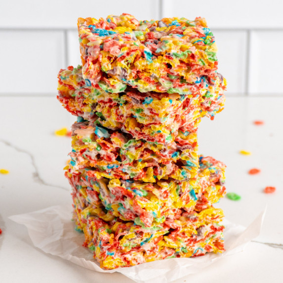 Fruity peeble rice crispy treats stacked on top of each other