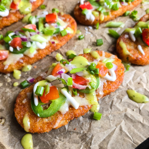 Golden brown hashbrowns topped with a colourful assortment of garnishes