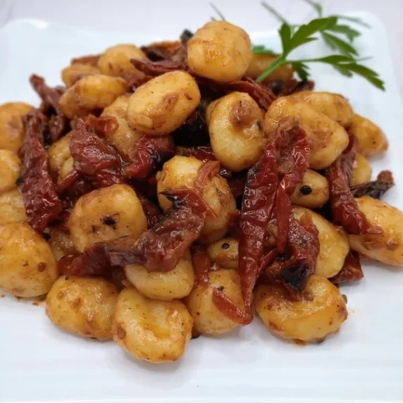 Sun-dried tomatoes sauteed in garlic and oil and mixed with gnocchi.