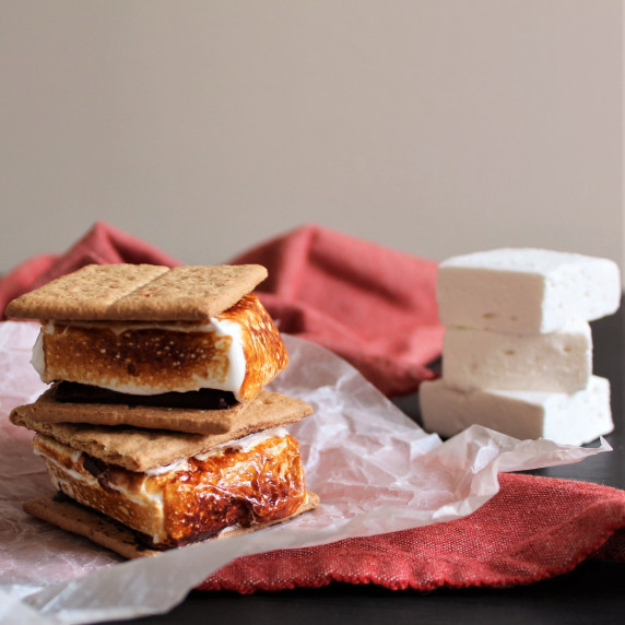 Two Gourmet S'Mores with additional homemade marshmallows in the background.