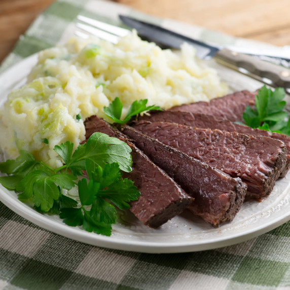 Corned beef on a plate with mashed potatoes