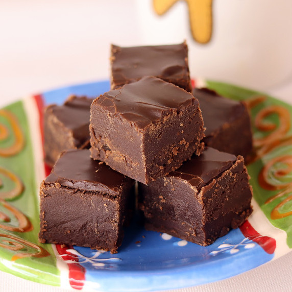 Pieces of old fashioned fudge arranged on a holiday plate against a white background