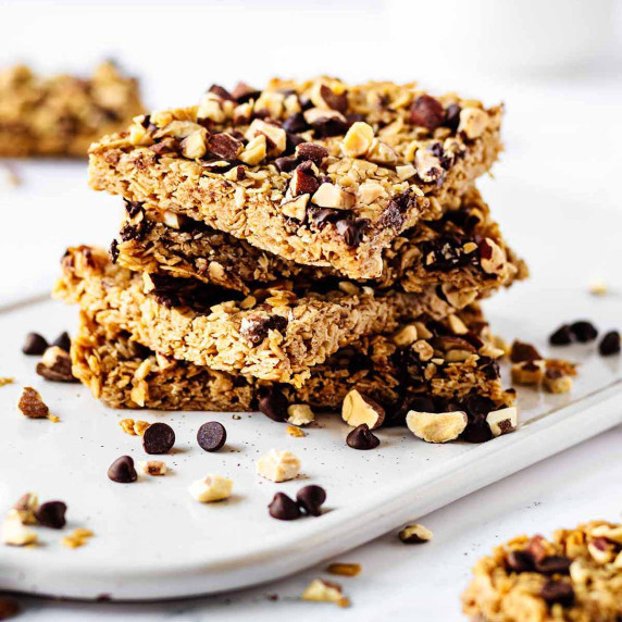 Stack of oat and honey granola bars on a white tray