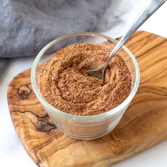 Ground Turkey Taco Seasoning in a small glass jar with a spoon.