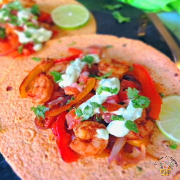 Healthy Shrimp Fajitas with shrimp, peppers, onions, salsa, avocado yogurt, and tomato tortilla