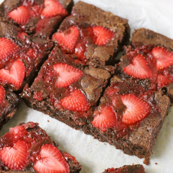 A top down shot of strawberry brownies on a white countertop
